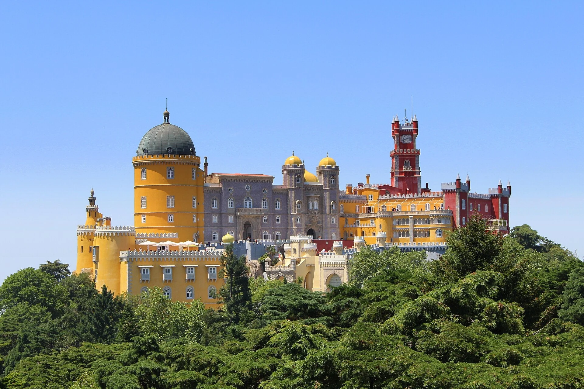 Pena Palace's yellow and red towers above the green hills of Sintra
